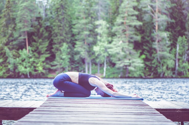 young attractive girl practicing yoga sitting child exercise balasana pose lake concept appeasement healthy lifestyle 182816 920